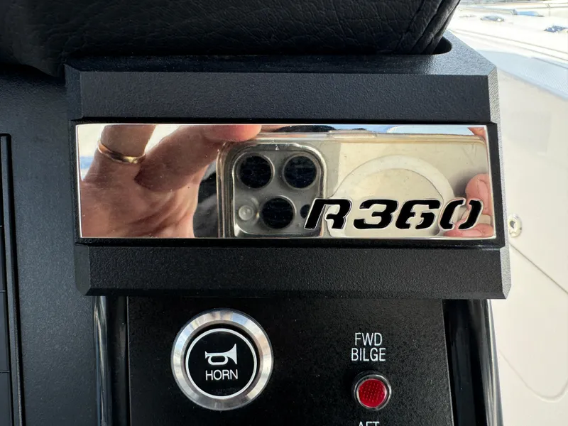 Slide: The Image of Control panel of 2025 Robalo R360 Center Console with horn and bilge buttons. - 26