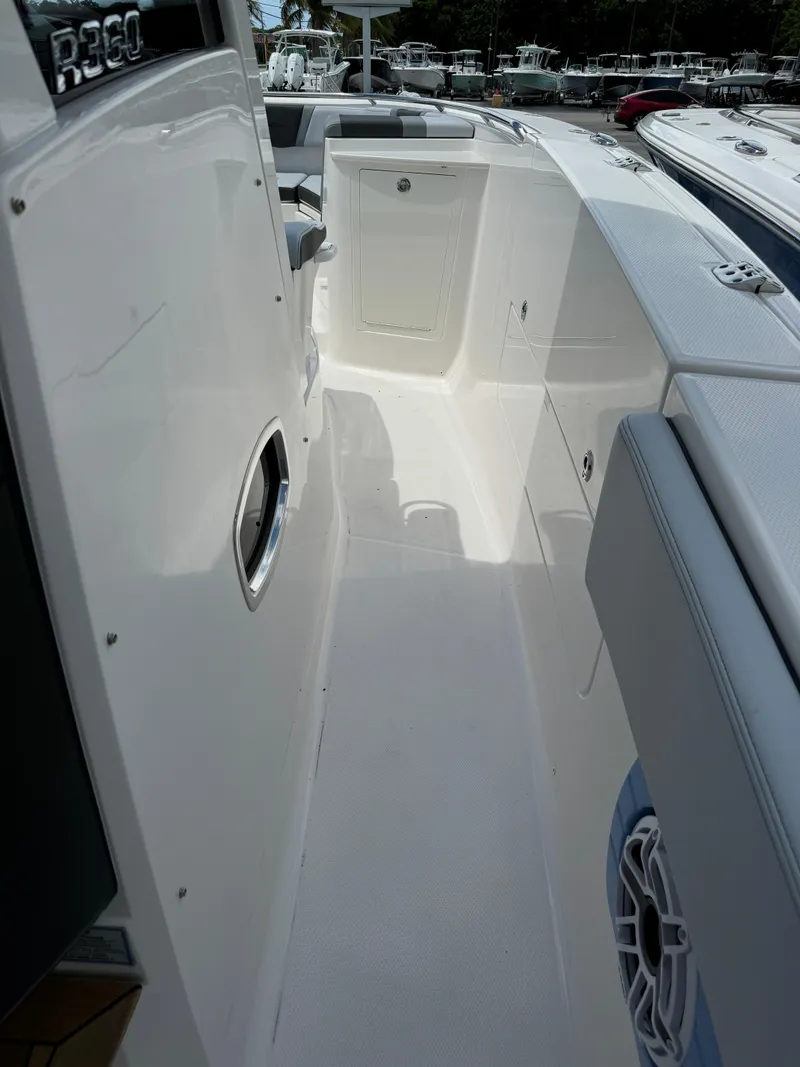 Slide: The Image of 2025 Robalo R360 Center Console boat interior, featuring sleek white design and modern amenities. - 31