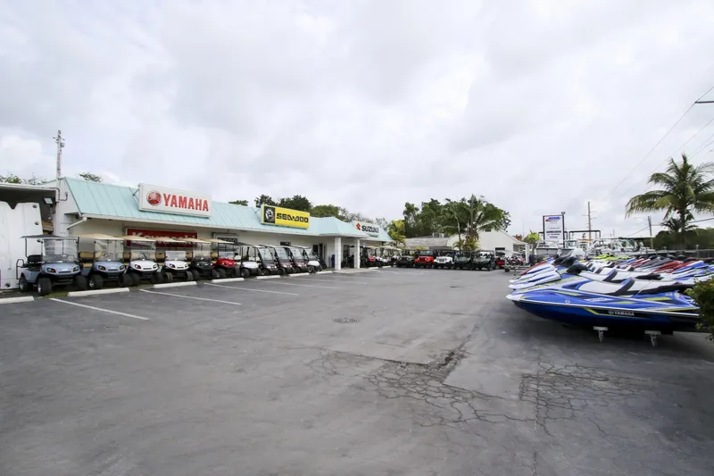 Slide: The Image of Outdoor display of Yamaha, Sea-Doo, and Robalo vehicles at a dealership. - 47