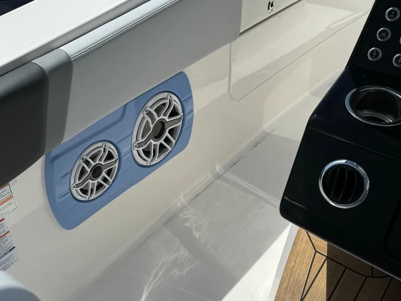 Slide: The Image of 2025 Robalo R360 Center Console boat interior with dual speakers and control panel. - 29