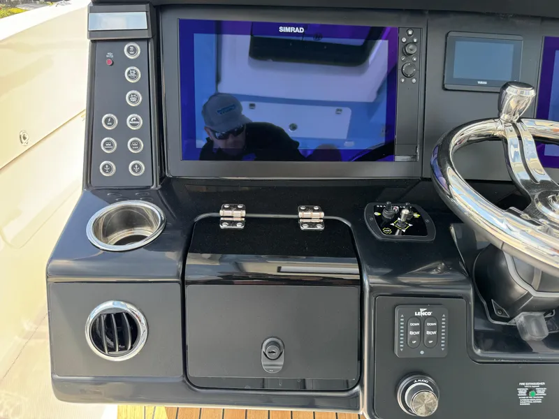 Slide: The Image of 2025 Robalo R360 Center Console dashboard with Simrad display and controls. - 20