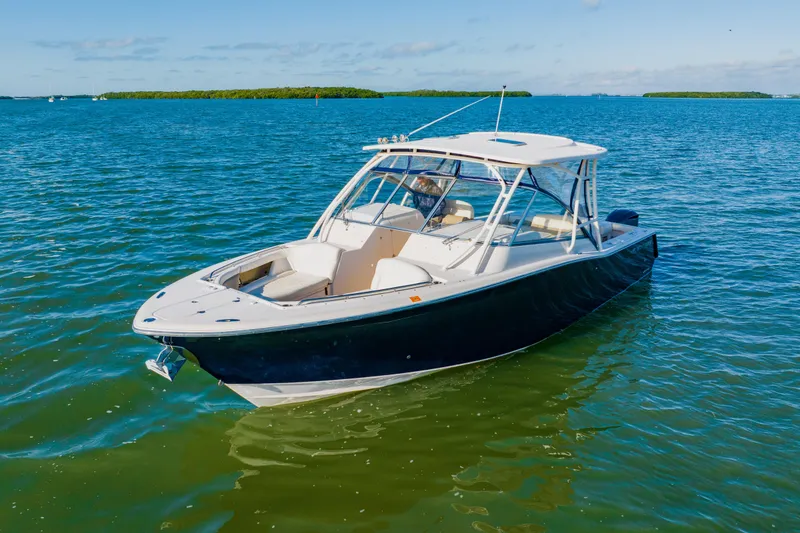 Slide: The Image of 2013 Grady-White Freedom 335 boat on calm blue water. - 12
