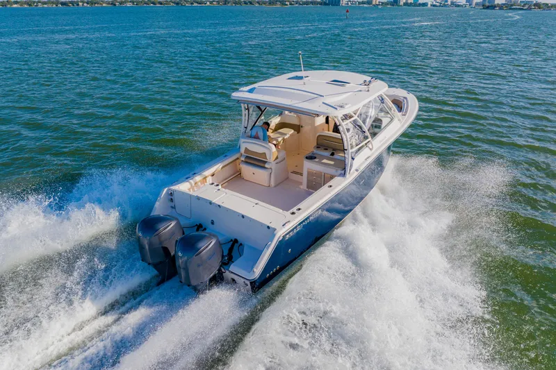 Slide: The Image of 2013 Grady-White Freedom 335 boat cruising on open water, rear view. - 17