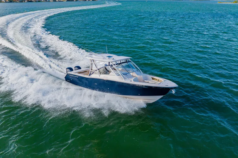 Slide: The Image of 2013 Grady-White Freedom 335 boat cruising on open water. - 22