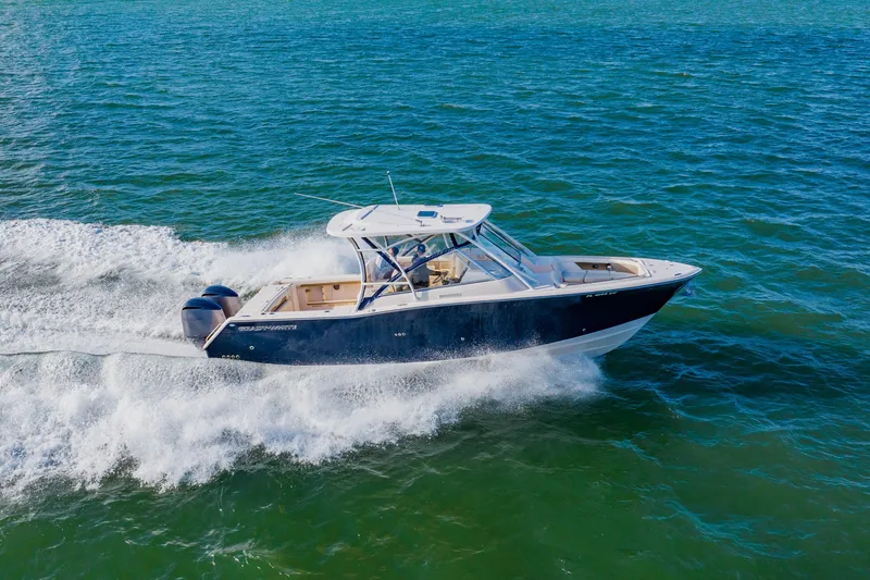 Slide: The Image of 2013 Grady-White Freedom 335 boat cruising on open water. - 23