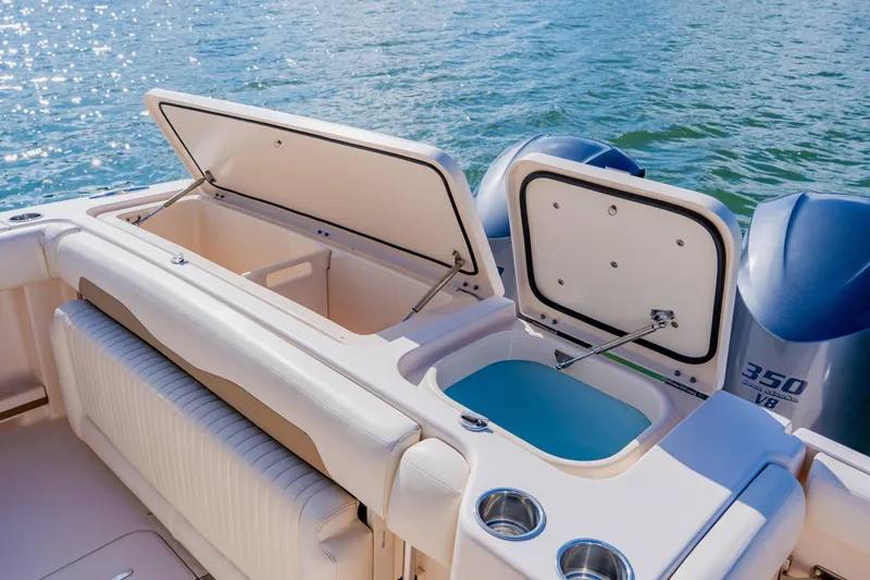 Slide: The Image of 2013 Grady-White Freedom 335 boat with open storage compartments and twin 350 V8 engines. - 29