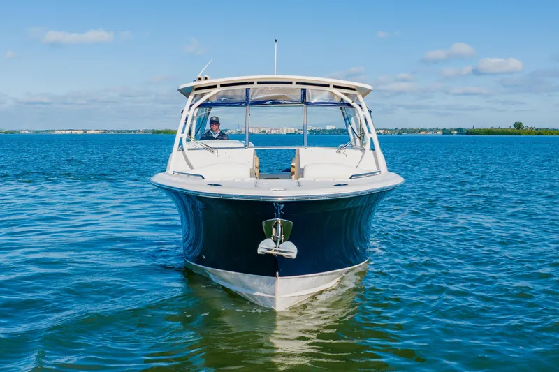 Slide: The Image of 2013 Grady-White Freedom 335 boat on calm blue water under clear sky. - 3