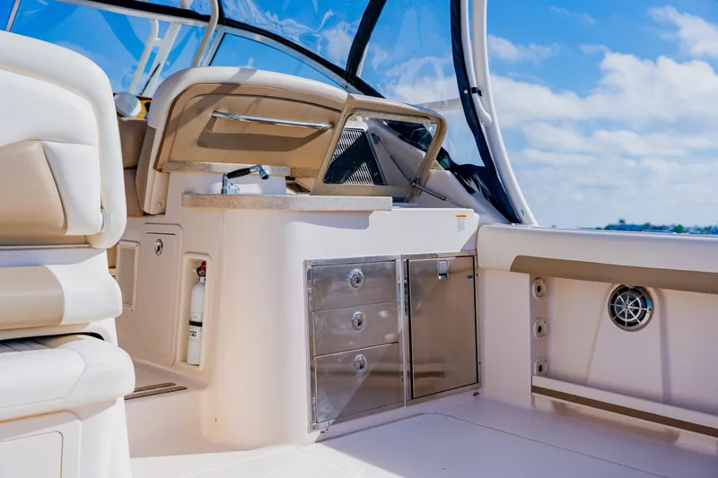 Slide: The Image of 2013 Grady-White Freedom 335 boat interior with seating, storage, and ocean view. - 30