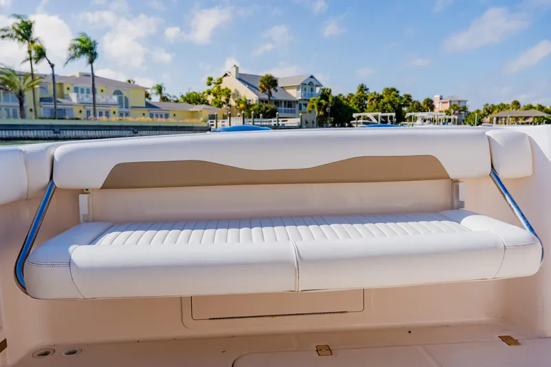 Slide: The Image of White seating on 2013 Grady-White Freedom 335 boat, with waterfront homes in background. - 33