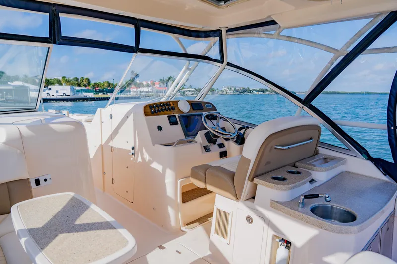 Slide: The Image of 2013 Grady-White Freedom 335 boat interior with helm, seating, and ocean view. - 36