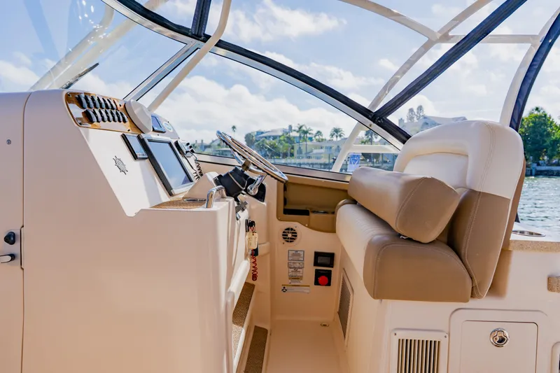 Slide: The Image of 2013 Grady-White Freedom 335 boat interior with steering wheel and controls. - 38