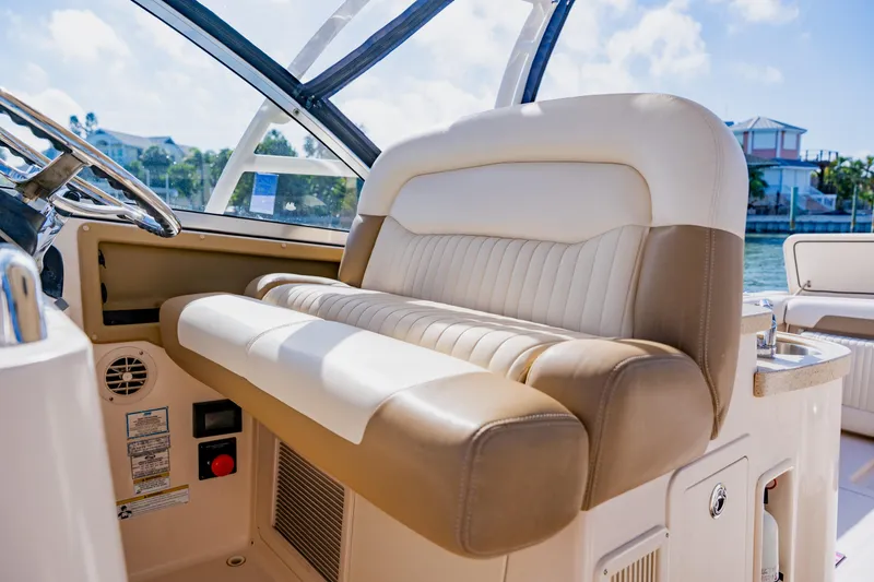 Slide: The Image of 2013 Grady-White Freedom 335 boat interior with luxurious seating and steering wheel. - 41