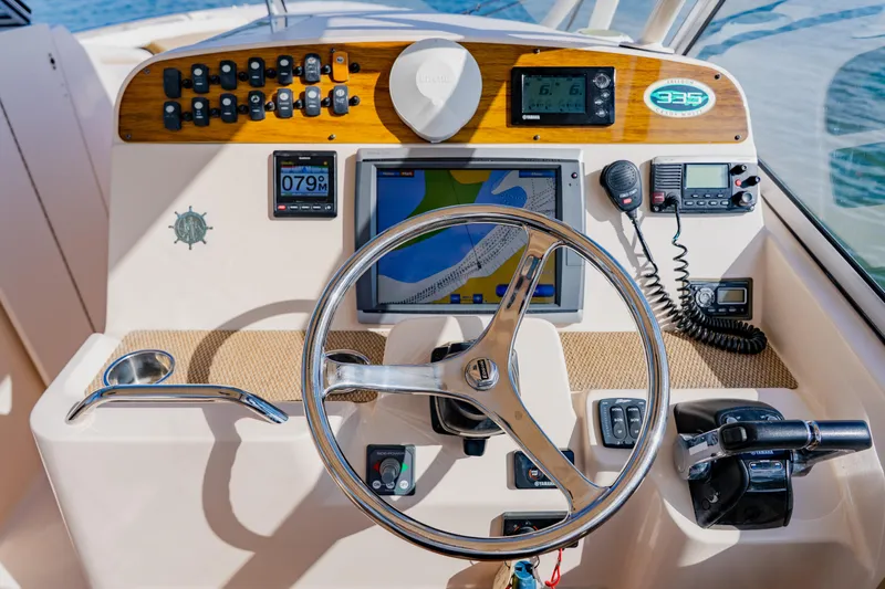 Slide: The Image of 2013 Grady-White Freedom 335 helm with navigation controls and steering wheel. - 42