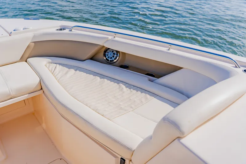 Slide: The Image of 2013 Grady-White Freedom 335 boat interior with cushioned seating and ocean view. - 45