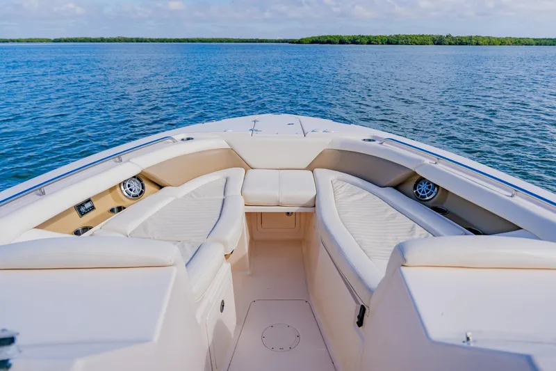 Slide: The Image of Bow seating area of 2013 Grady-White Freedom 335 boat on calm water. - 47