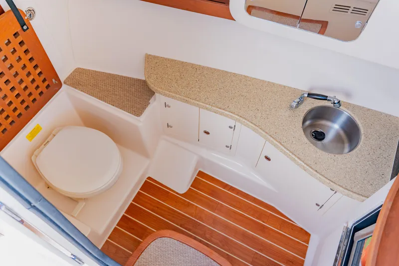 Slide: The Image of 2013 Grady-White Freedom 335 boat bathroom with sink, toilet, and wooden flooring. - 51