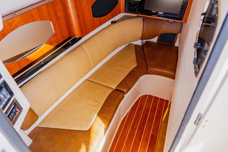 Slide: The Image of 2013 Grady-White Freedom 335 cabin interior with leather seating and wood flooring. - 52