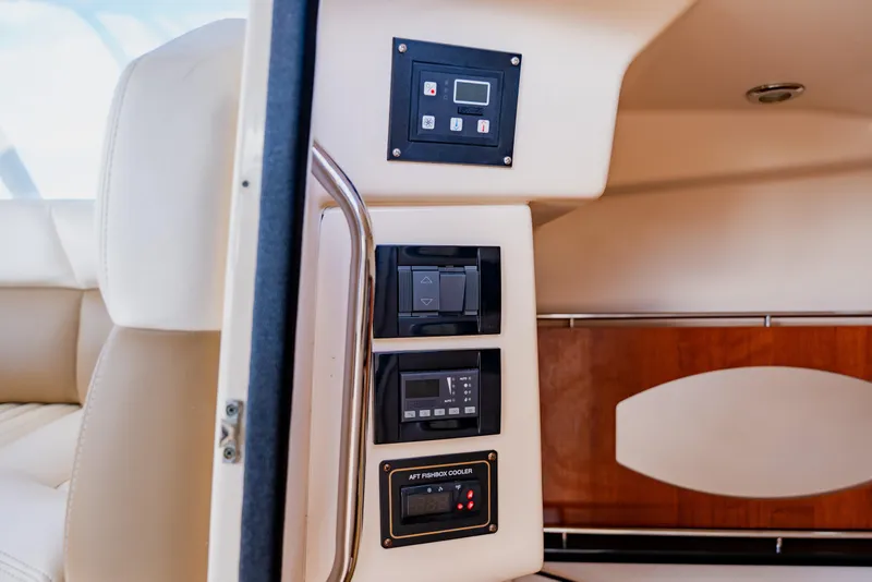 Slide: The Image of Control panel inside 2013 Grady-White Freedom 335 boat, featuring various switches and displays. - 53