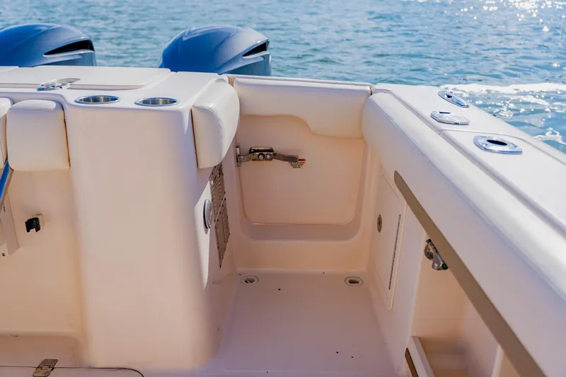 Slide: The Image of 2013 Grady-White Freedom 335 boat interior with cup holders and ocean backdrop. - 55