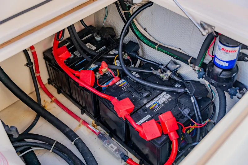 Slide: The Image of Battery compartment of 2013 Grady-White Freedom 335 boat with wiring and components. - 58