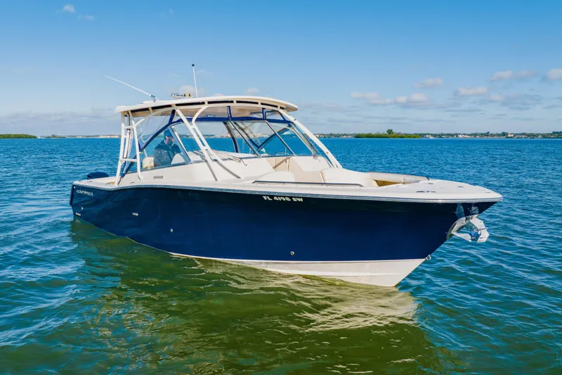 Slide: The Image of 2013 Grady-White Freedom 335 boat on calm blue water under clear sky. - 9
