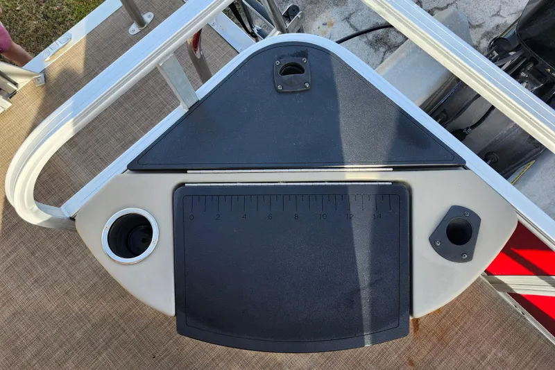 Slide: The Image of 2023 Sun Tracker Bass Buggy 18 DLX fishing station with cup holders and measuring board. - 10