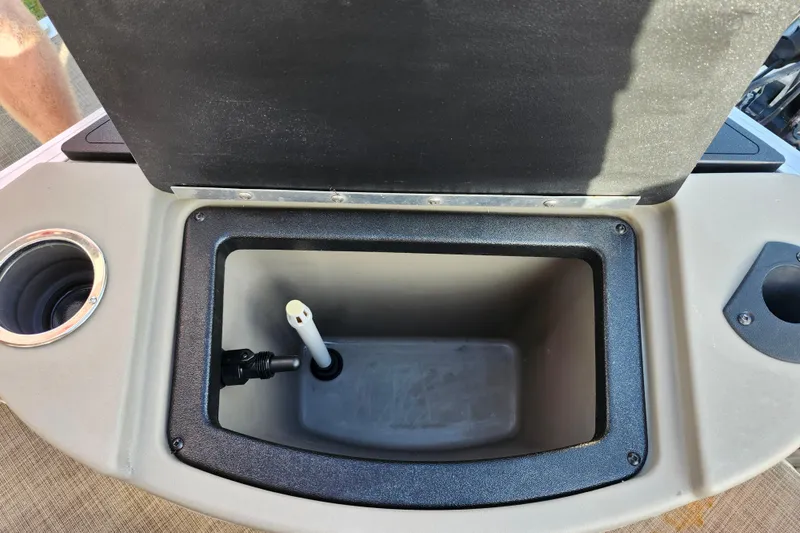 Slide: The Image of 2023 Sun Tracker Bass Buggy 18 DLX livewell with open lid and cup holder. - 11