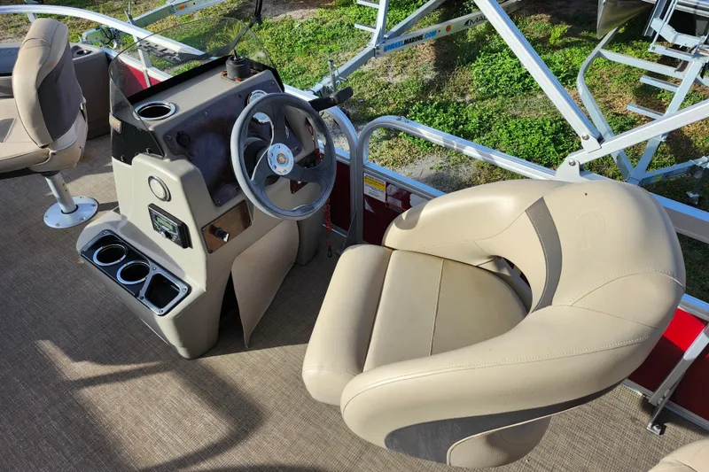Slide: The Image of 2023 Sun Tracker Bass Buggy 18 DLX boat interior with steering console and seating. - 13