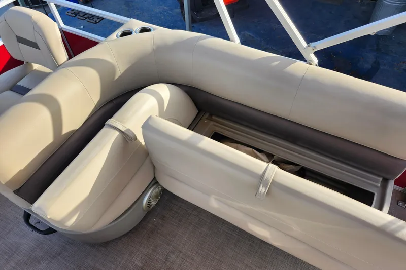 Slide: The Image of 2023 Sun Tracker Bass Buggy 18 DLX pontoon boat with beige seating and storage compartment. - 17