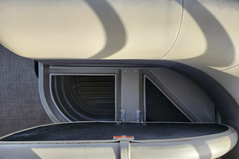 Slide: The Image of 2023 Sun Tracker Bass Buggy 18 DLX storage compartment with cushioned seating. - 19