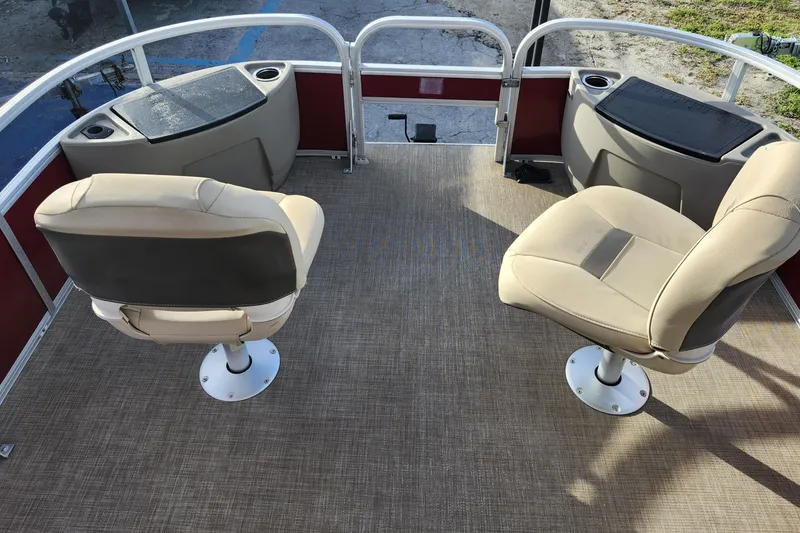 Slide: The Image of 2023 Sun Tracker Bass Buggy 18 DLX interior with two swivel seats and storage compartments. - 20