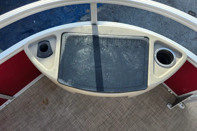 Slide: The Image of 2023 Sun Tracker Bass Buggy 18 DLX fishing station with ruler and cup holder. - 23