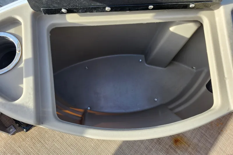 Slide: The Image of Storage compartment of 2023 Sun Tracker Bass Buggy 18 DLX boat, featuring cup holder. - 26