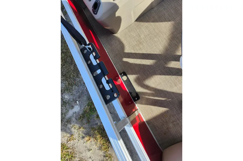 Slide: The Image of 2023 Sun Tracker Bass Buggy 18 DLX interior detail with red and beige accents. - 27