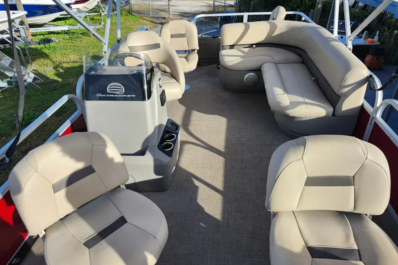 Slide: The Image of 2023 Sun Tracker Bass Buggy 18 DLX pontoon boat interior with beige seating. - 28