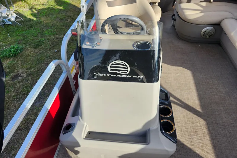Slide: The Image of 2023 Sun Tracker Bass Buggy 18 DLX boat console with steering wheel and cup holders. - 30