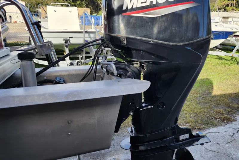 Slide: The Image of 2023 Sun Tracker Bass Buggy 18 DLX with Mercury outboard motor, parked outdoors. - 33