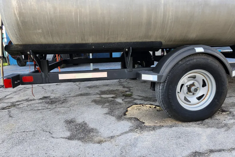 Slide: The Image of 2023 Sun Tracker Bass Buggy 18 DLX trailer on cracked pavement. - 36