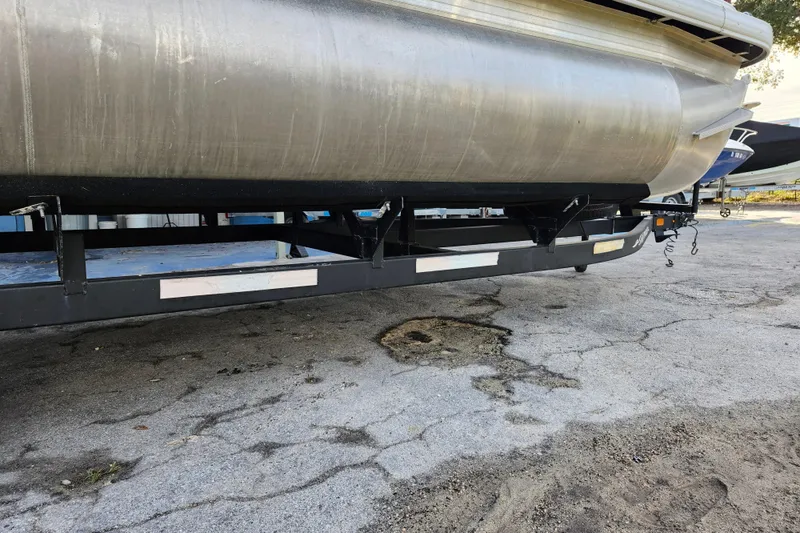 Slide: The Image of 2023 Sun Tracker Bass Buggy 18 DLX pontoon boat on trailer, side view. - 37