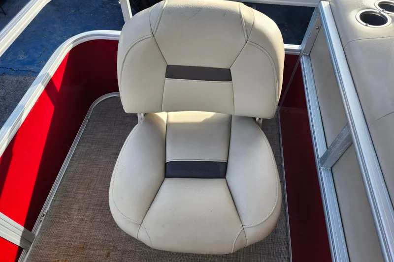 Slide: The Image of 2023 Sun Tracker Bass Buggy 18 DLX boat seat, beige upholstery, red interior accents. - 9