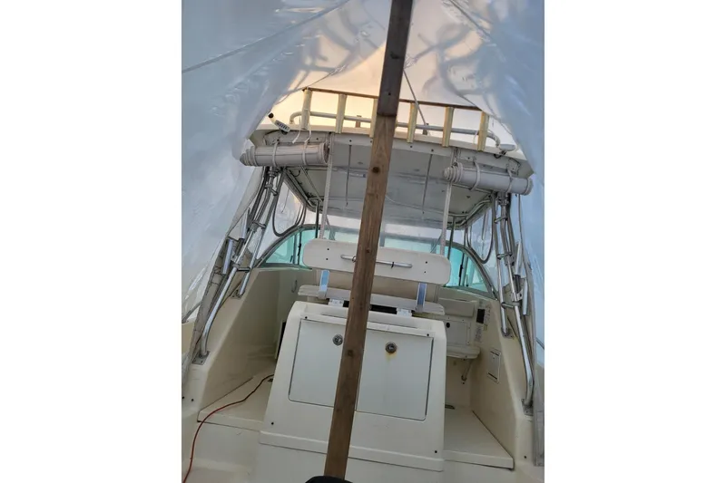 Slide: The Image of 2000 Pursuit 3070 Offshore Center Console boat interior under protective cover. - 12