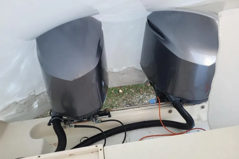 Slide: The Image of Twin outboard motors on a 2000 Pursuit 3070 Offshore Center Console boat. - 13