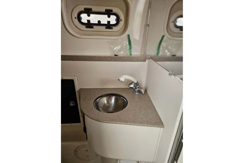 Slide: The Image of Compact sink area in 2000 Pursuit 3070 Offshore Center Console boat. - 8