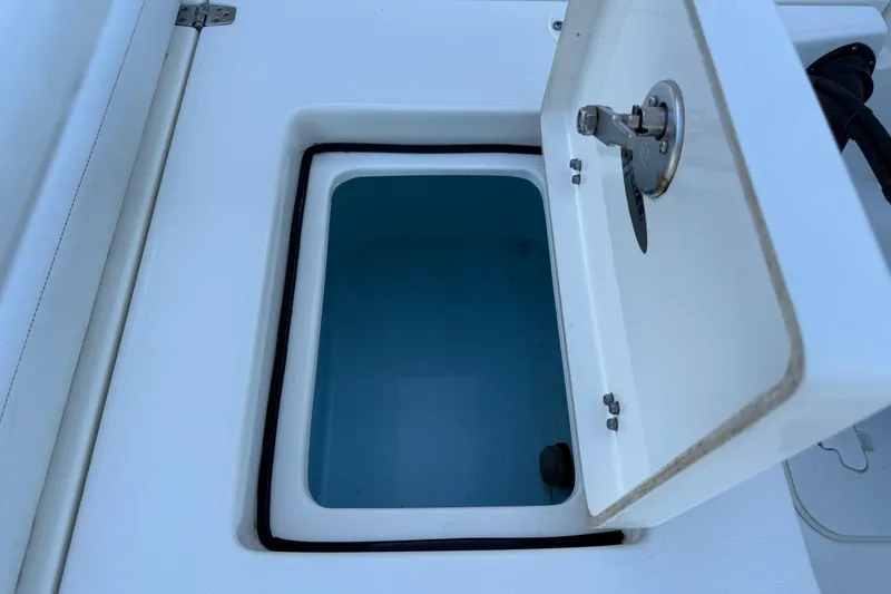 Slide: The Image of Open storage compartment on 2022 Hewes Redfisher 18 boat, showcasing interior space. - 11