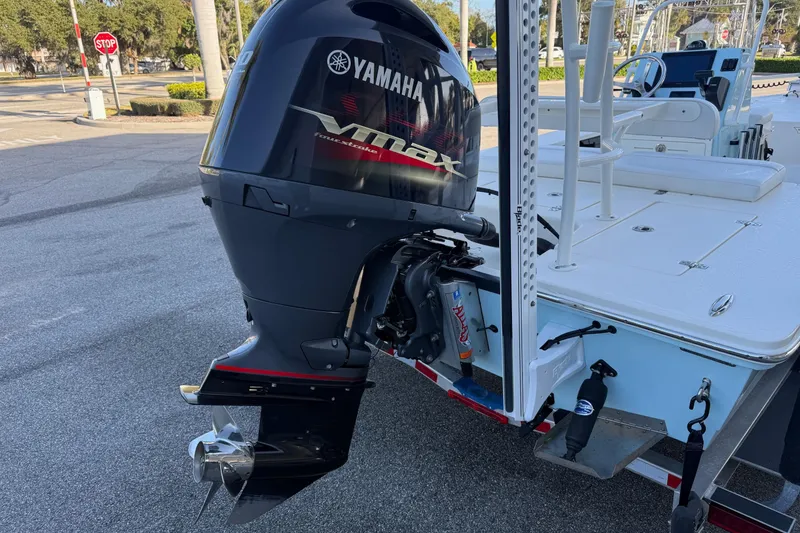 Slide: The Image of 2022 Hewes Redfisher 18 boat with Yamaha VMAX outboard motor in a parking lot. - 4