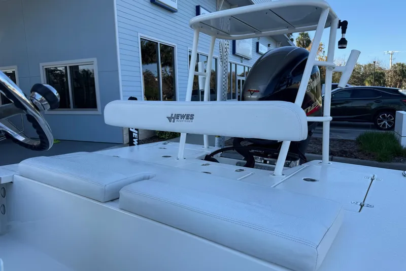 Slide: The Image of 2022 Hewes Redfisher 18 boat interior with steering wheel and seating. - 8