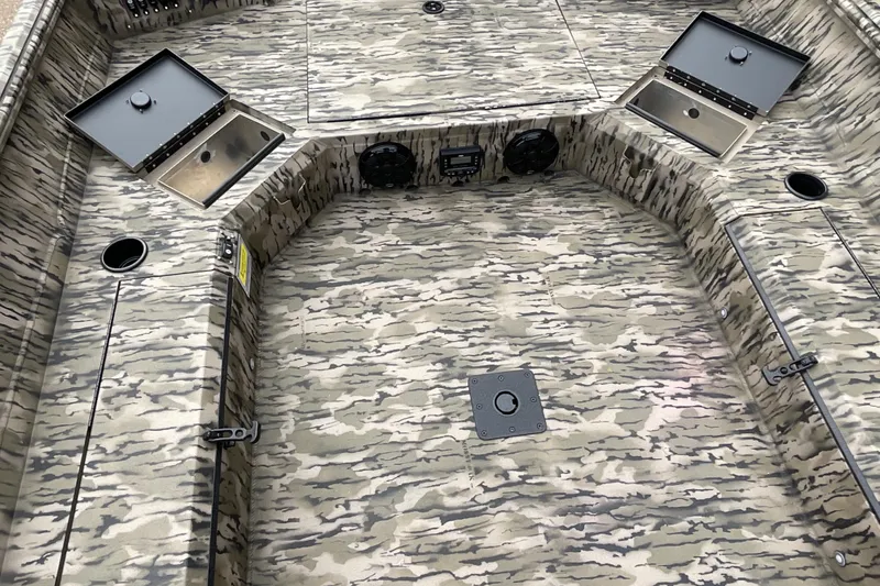 Slide: The Image of 2026 Excel Tomahawk 183 boat interior with camouflage design and storage compartments. - 4