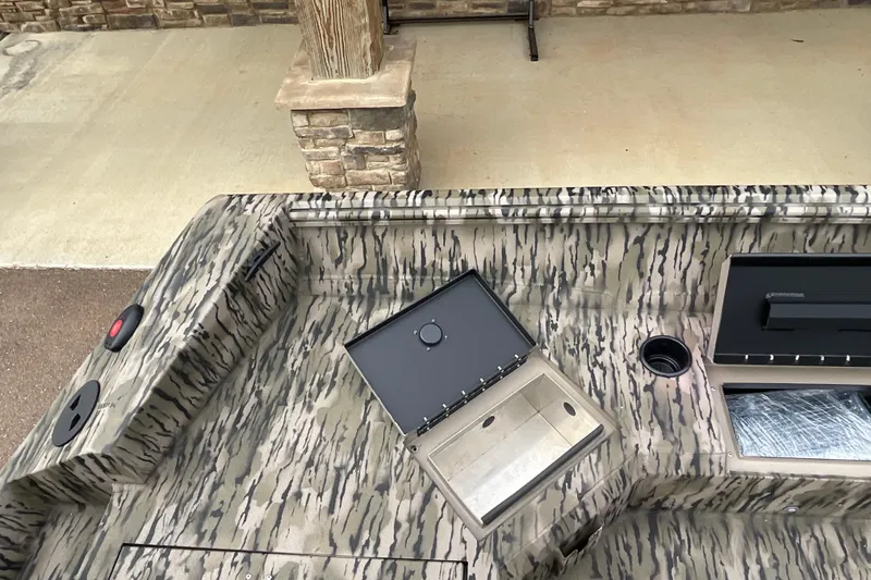 Slide: The Image of 2026 Excel Tomahawk 183 boat interior with camouflage design and open storage compartments. - 8