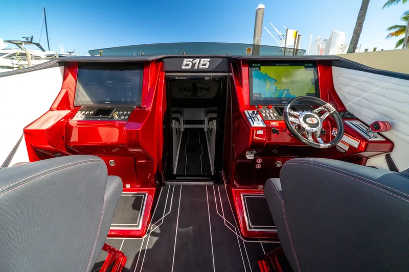 Slide: The Image of Interior of 2020 Cigarette 515 boat with advanced navigation system and sleek red design. - 1