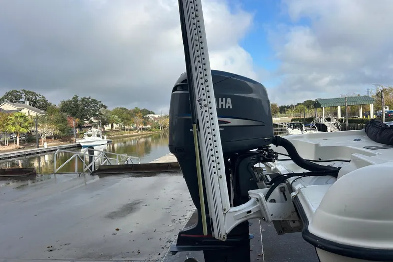 Slide: The Image of 2006 Triton 22 Bay Flight boat with Yamaha motor at a scenic dock. - 10
